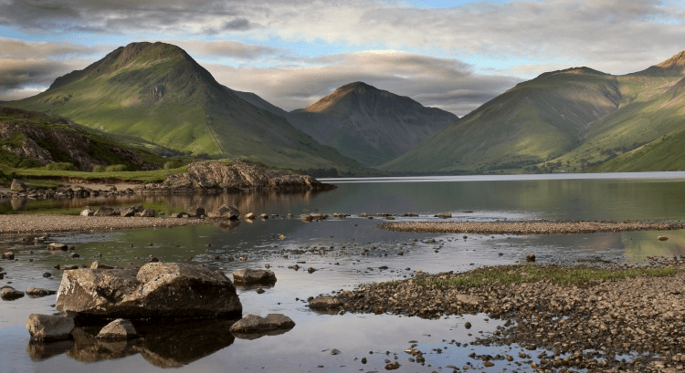 The lakeland fells stand over the clear water of Wastwater tarn.